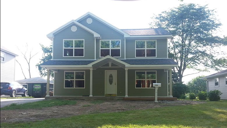 Green color house after siding installation