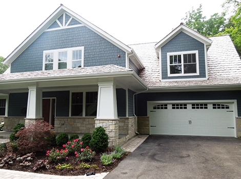 Charming exterior transformation project photo after fiber cement installation and roof replacement in Northbrook