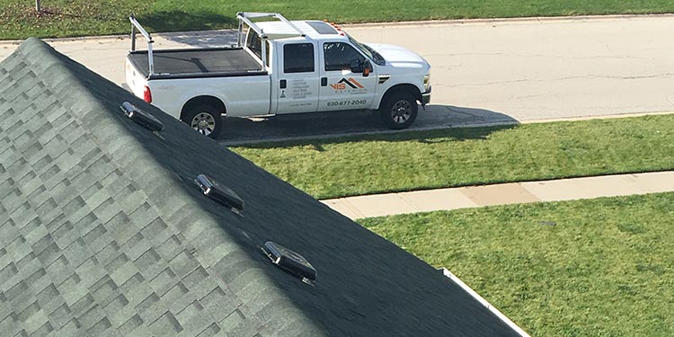 Roofing contractor car from a rooftop