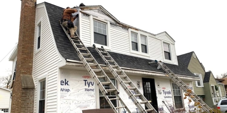 Siding installer on the roof