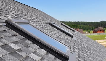 Asphalt shingles house roofing construction with attic roof windows