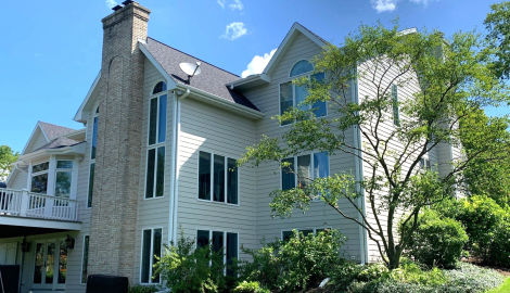 LP SmartSide ExpertFinish siding installation and guttering in St. Charles project photo 1