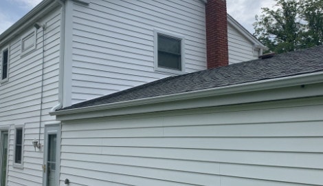 Vinyl siding installation & gutters replacement after hail damage in Downers Grove project photo 1