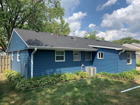 Vinyl siding and shingle roof replacement after hail damage in Woodridge project photo