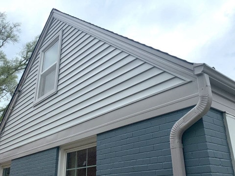 Vinyl siding installation and shingle roof replacement after hail damage in Clarendon Hills project photo 2