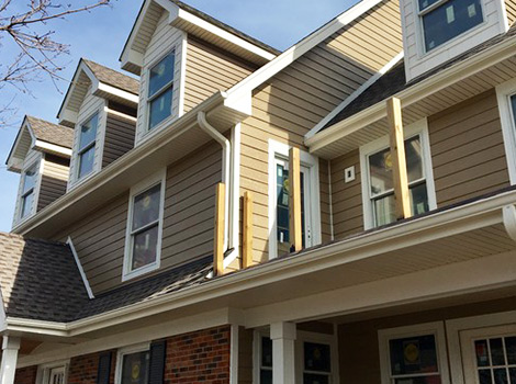 Residential house with the new exterior after LP Diamond Kote siding and gutters installation in Naperville